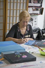 Natalie Signs her Work
